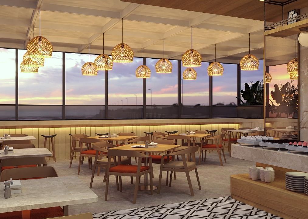 Seating area with modern lights above inside the restaurant - Livancia The Sojourn, Bangalore