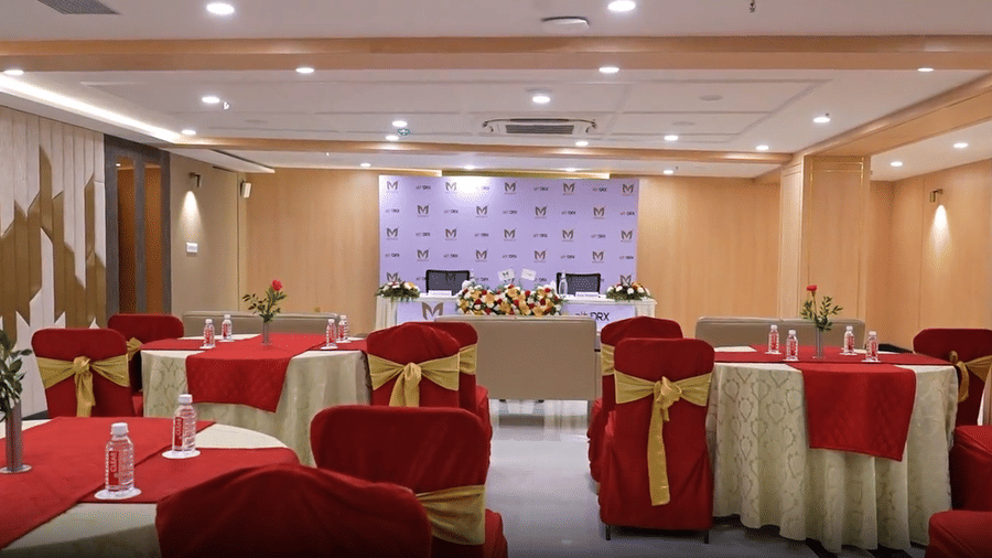 A banquet hall setup in Coronet Ball Room at The Monarch Hotel, Brigade Road with round tables arranged for a formal event.