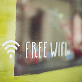 a sign on a glass saying free wifi with the logo of wifi