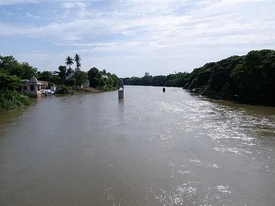 Flowing River Kaveri surrounded by lush greenery, providing a peaceful natural backdrop near the temple of Dharasuram