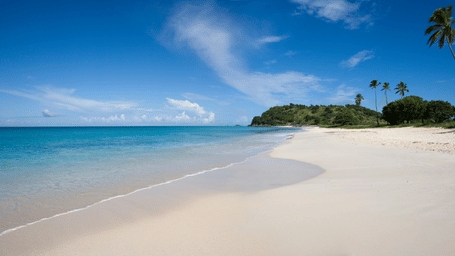 Pristine white sand beach with crystal-clear turquoise water.
