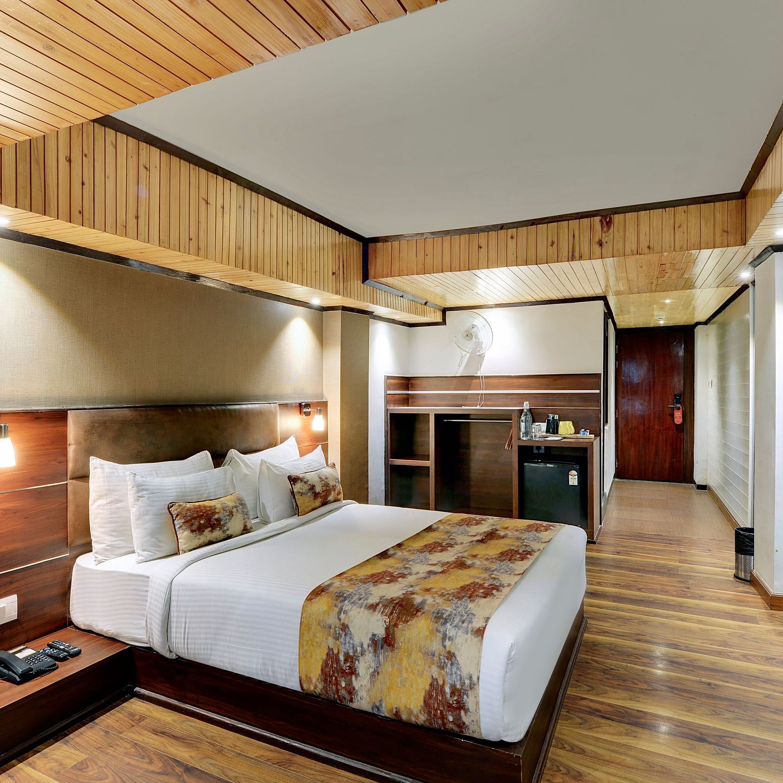 Image of a room with a bed, a television mounted on a stone wall at Yashshree Mall Road, Darjeeling.