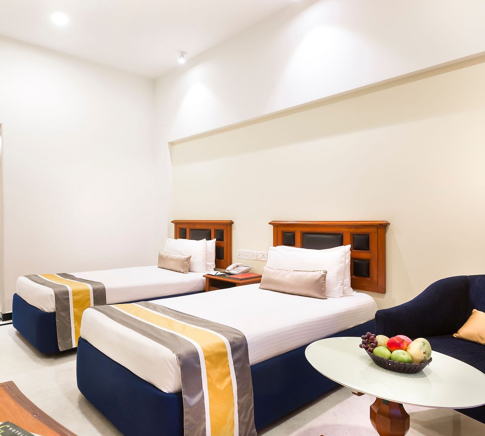 A view of the twin beds of a Deluxe room at Regency Kanchipuram by GRT Hotels.