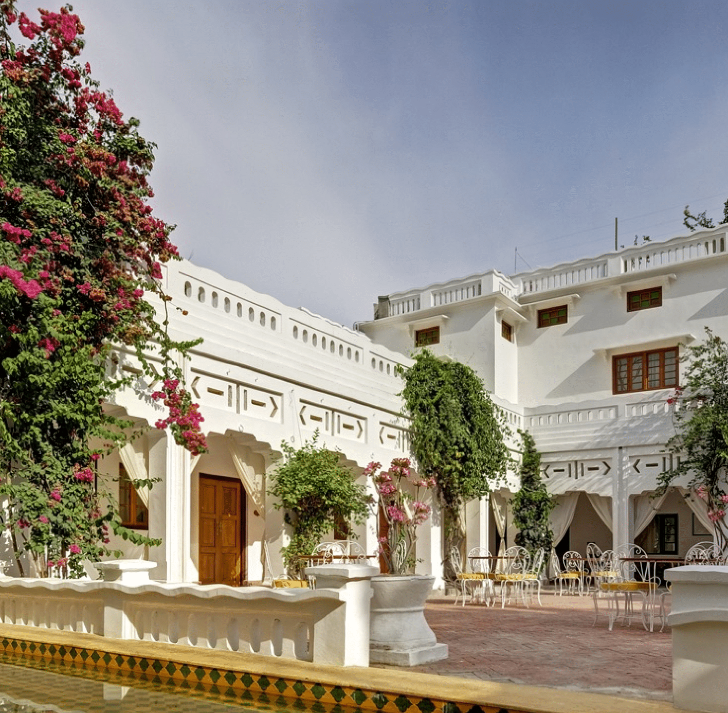 Facade of Saraca Lucknow featuring trees with flowers