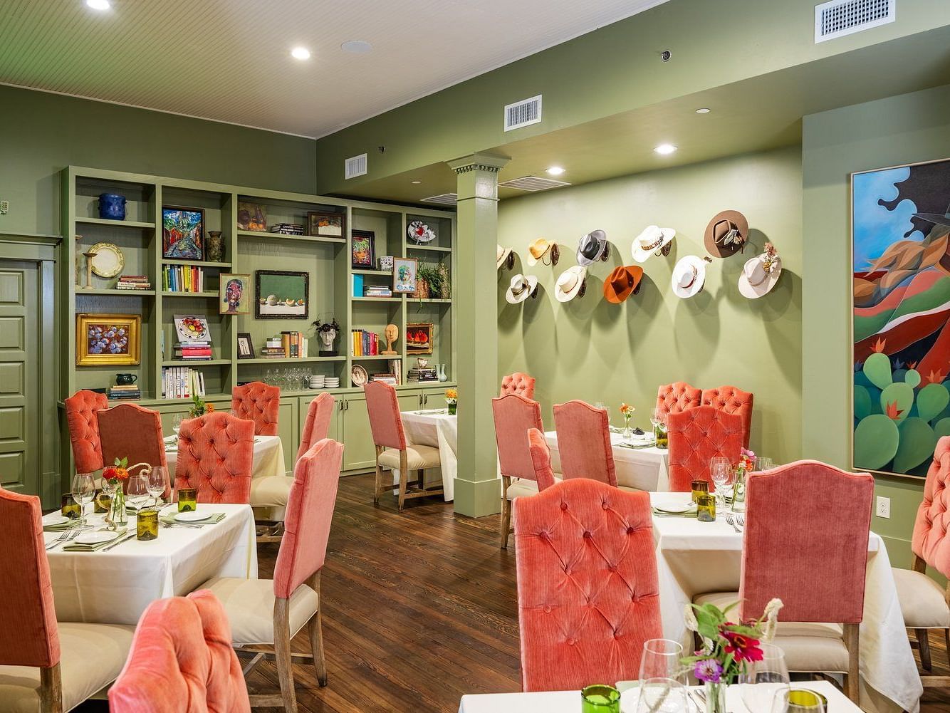 A restaurant interior, featuring chairs, decorated walls, and a neatly arranged dining setup.- The Grand Hotel & Ballroom, McKinney