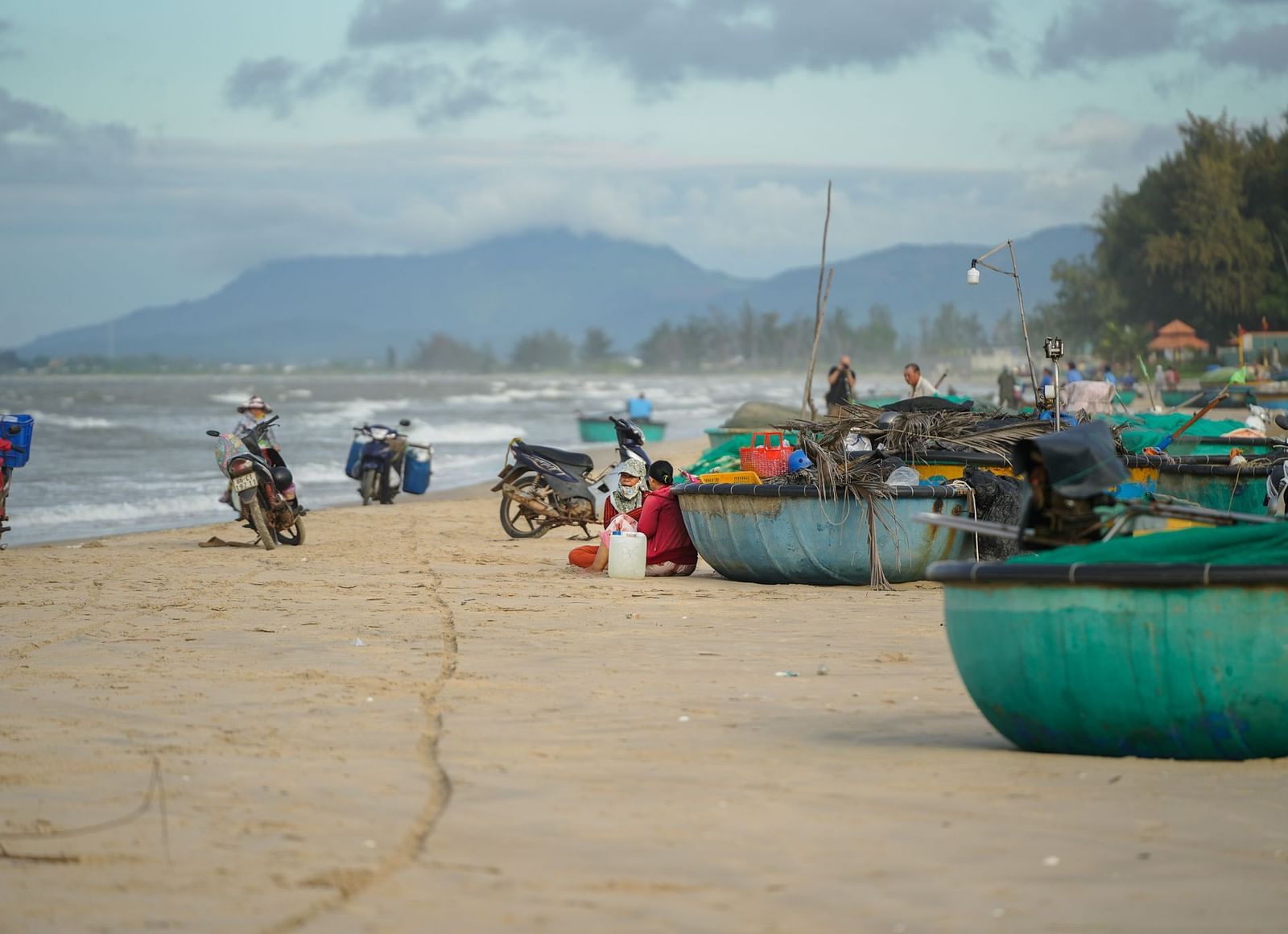 Fishing boats docked on the beach on a cloudy day - WoCAL Retreat Ke Ga