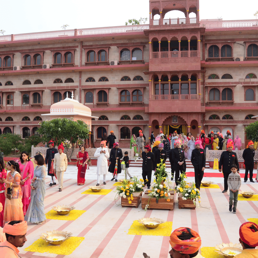 Grand wedding ceremony in a palace courtyard with traditional decor.