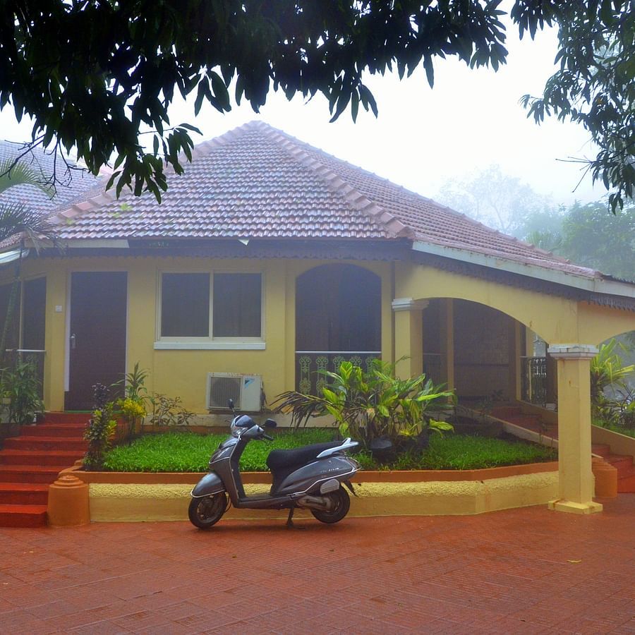 mist-covered view of the yellow exterior facade of a villa - Zara's Resort