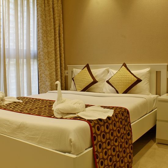 Side view of the bedroom with plush bed side table and modern interior - Maxxvalue Apartment, Hiranandani, Powai