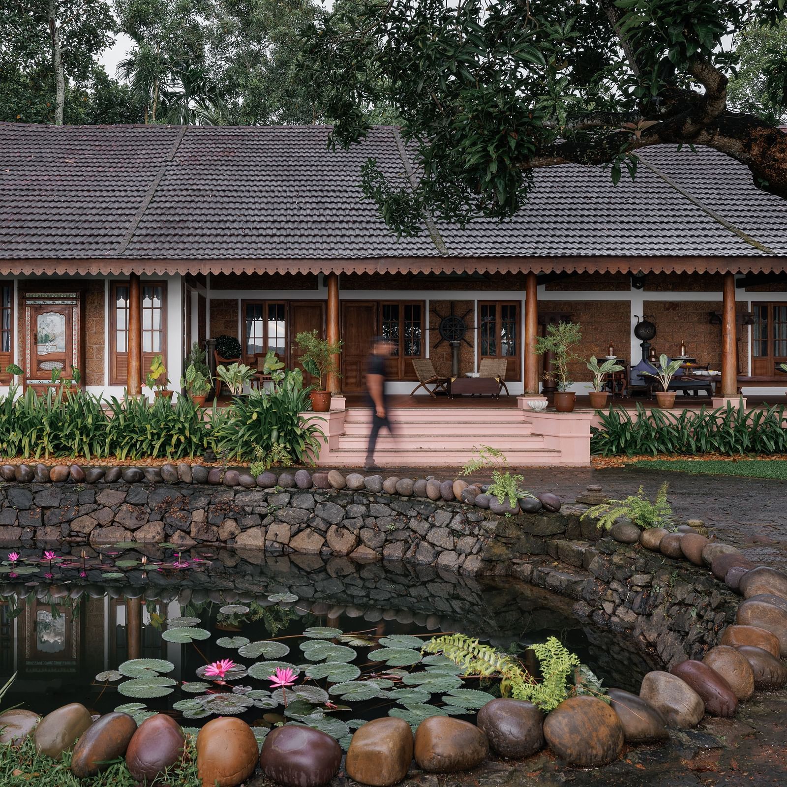 A facade image of BluSalzz Villas - Muhamma Resort, Alleppey with a pond in front of the resort