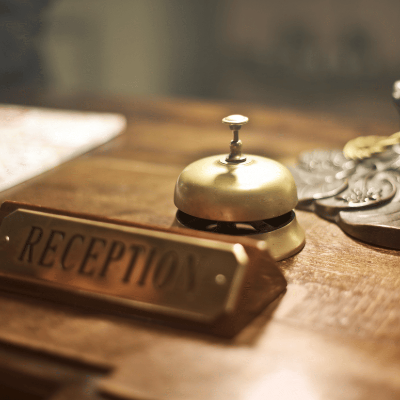 A close up shot of a desk with a plate having reception written on it.