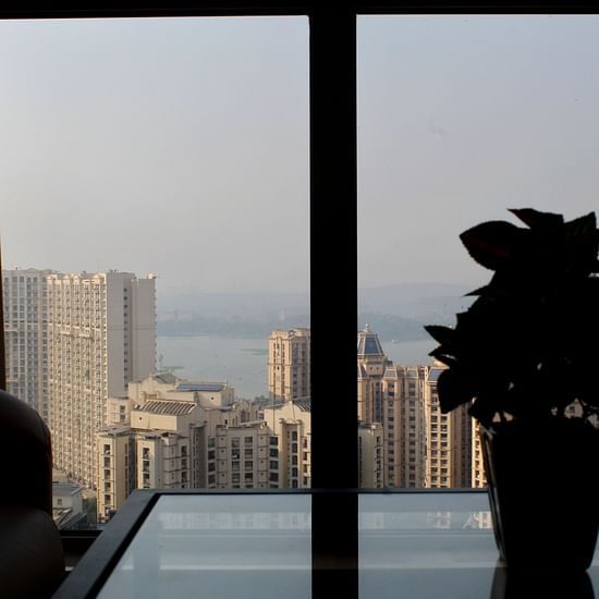 An outside view of a lake from the building - Maxxvalue Apartment Powai