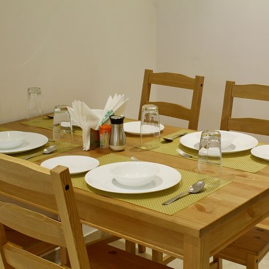 Dining Table featuring plates and cutlery- Maxxvalue Apartment Hiranandani Powai