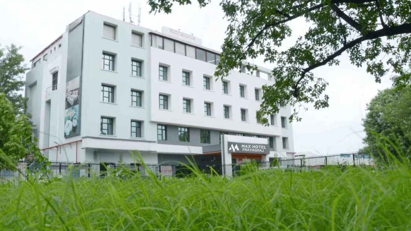 Exterior view of Max Hotel Prayagraj surrounded by greenery, highlighting the hotel’s modern architecture.