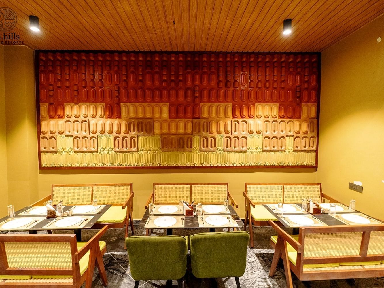 Elegant restaurant interior with green chairs and wooden accents, designed for a comfortable dining experience - Sea Hills Resort, Swaraj Dweep (Havelock)
