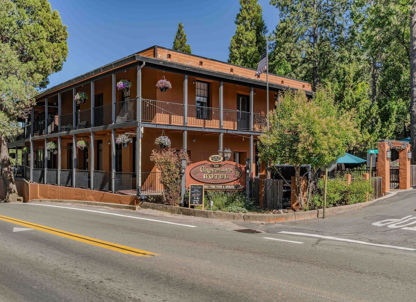 Exterior of a cabin at The Groveland Hotel during the day with the hotel's signage in view.