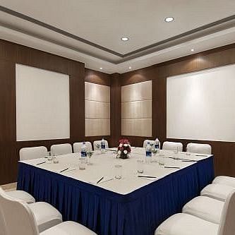 Board Room with a large square table and seating arranged on all four sides, ready for meetings and conferences at Inde Signature Tower, Gurgaon
