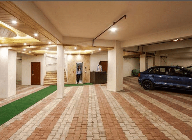 Image of an expansive parking space with some cars parked around | DLS La Serene Manali