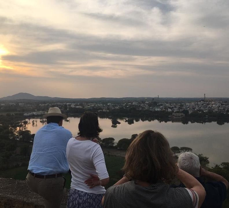image of a group of tourists soaking in the sunset as they watch the lake - Dev Shree, Deogarh