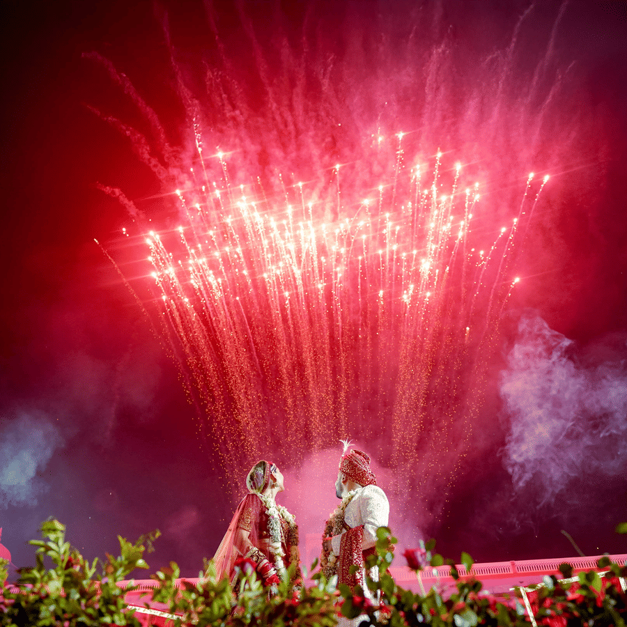 Grand fireworks display lighting up the sky during a wedding celebration at Umaid Palace.