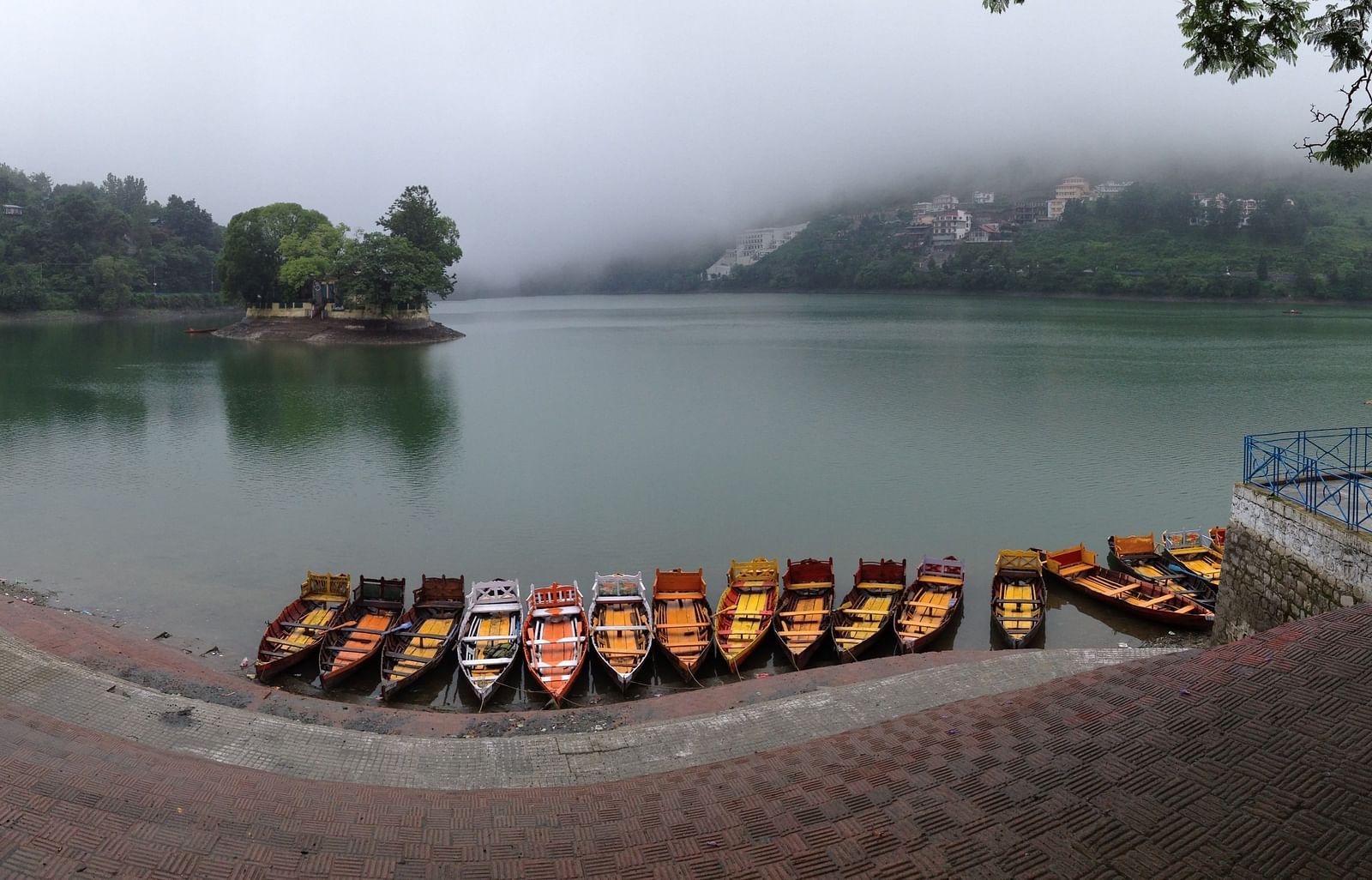 Picturesque lake with wooden boats gently bobbing on the calm waters.