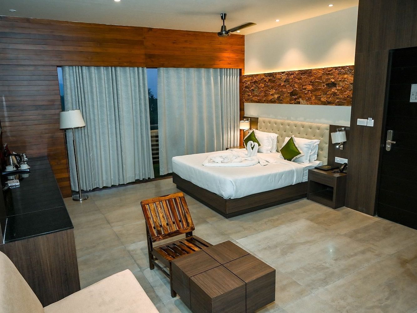 A hotel room with a large bed, a television, and a window with dark curtains - Sea Hills Hotels, Sri Vijayapuram (Port Blair)