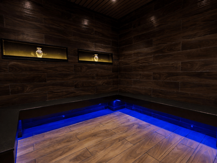 A room with wooden paneling and blue LED floor lighting  - Manor Sports & Wellness Hotel