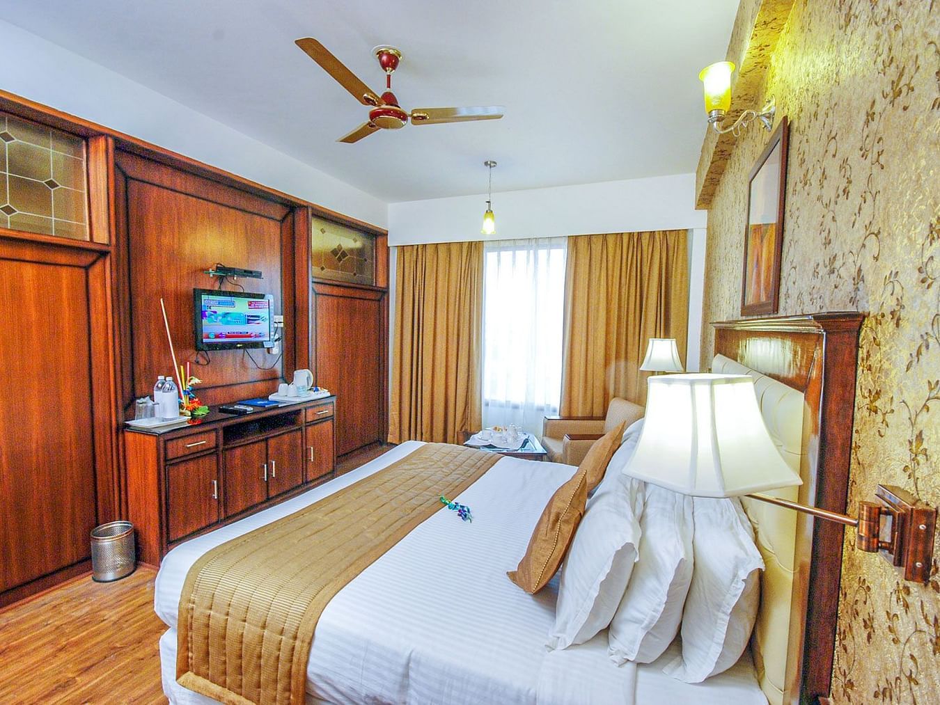 A side view of a room with a bed and TV | Sun Park Hotel & Banquet, Chandigarh - Zirakpur