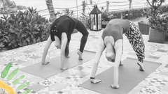 black and white image of two people doing yoga  0