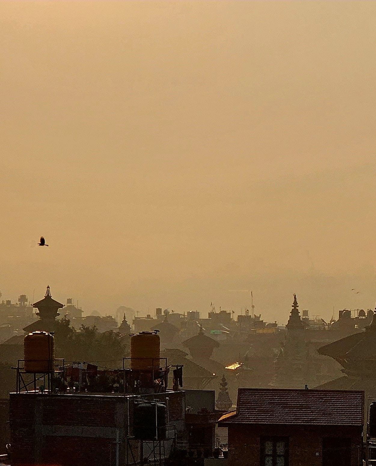 The rooftop offers a city view with the silhouette of buildings against the skyline.