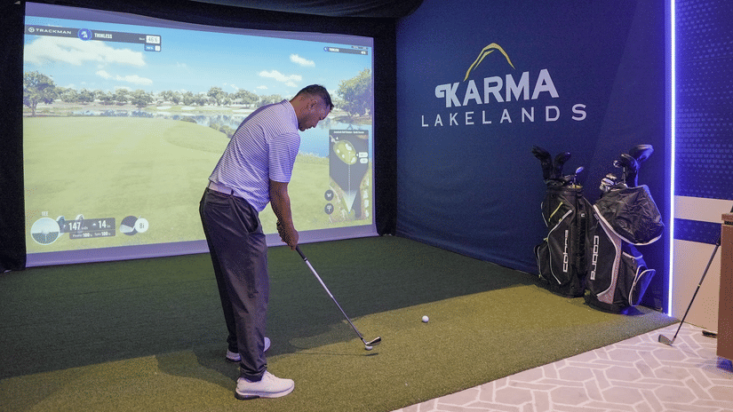 A person enjoying indoor Golf Simulator at Karma Lakelands