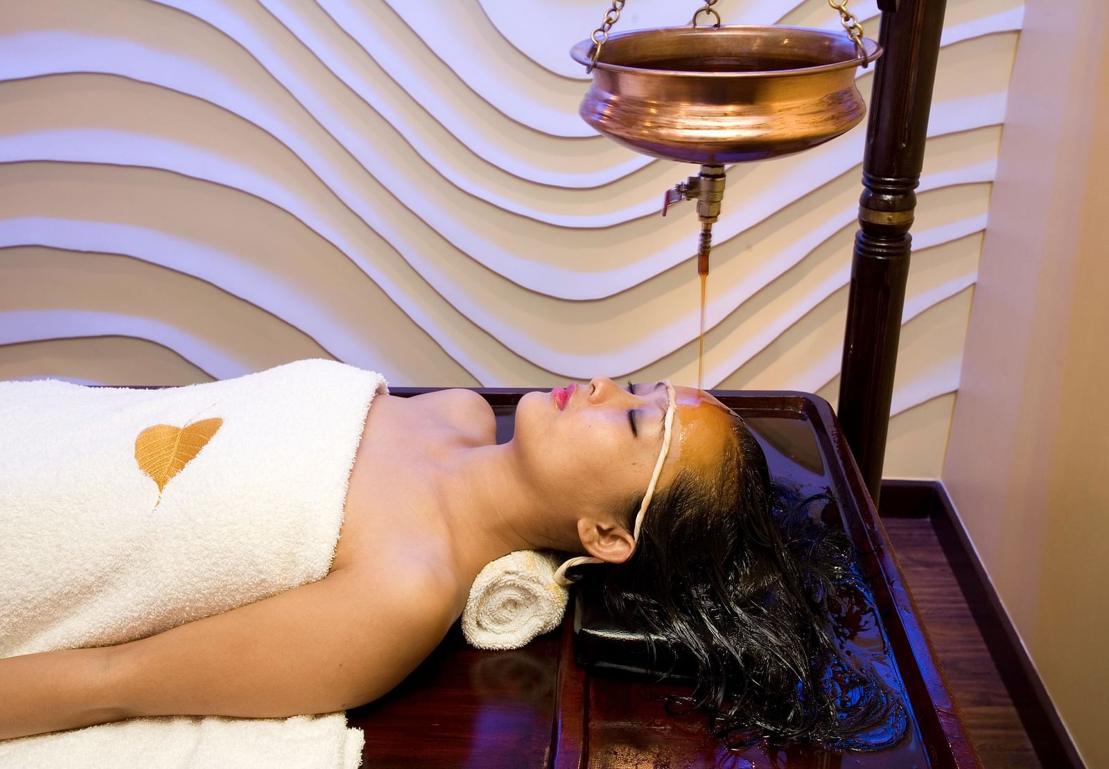 Lady getting a spa treatment at  Grand Chennai By GRT Hotels.