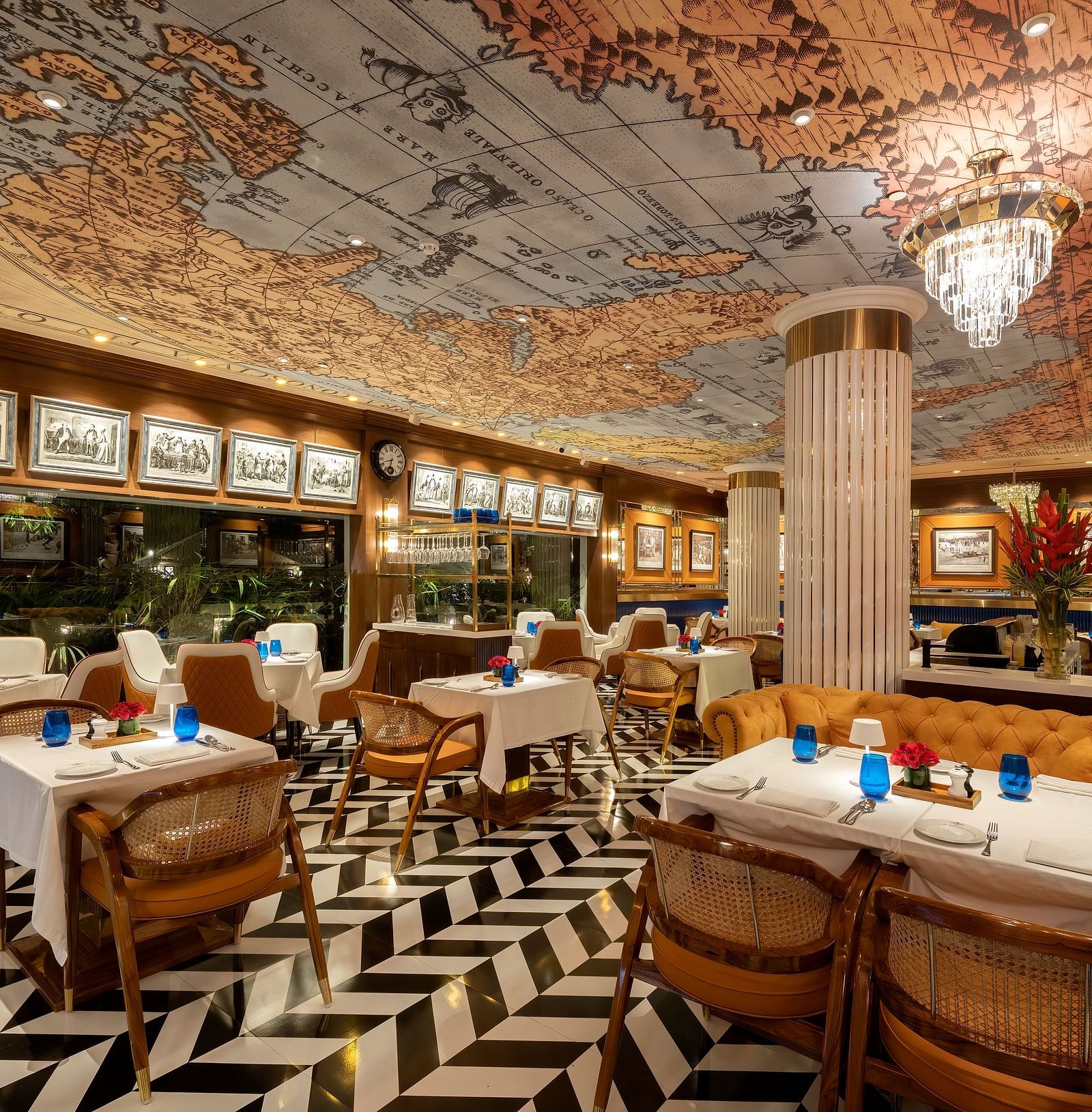 image of the pickwick multi cuisine restaurant in delhi with stunning interiors and a ceiling with a world map - The Claridges New Delhi