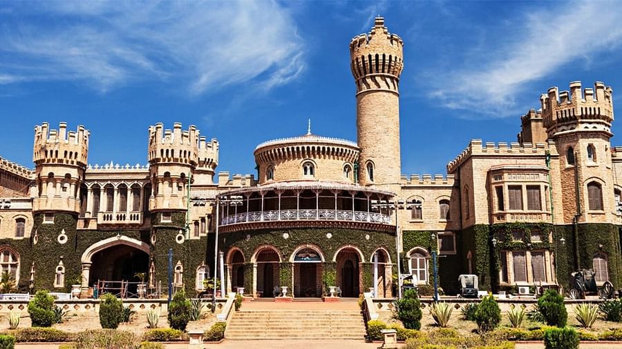 Majestic view of Bangalore Palace with Tudor-style architecture, turrets, and sprawling lawns.