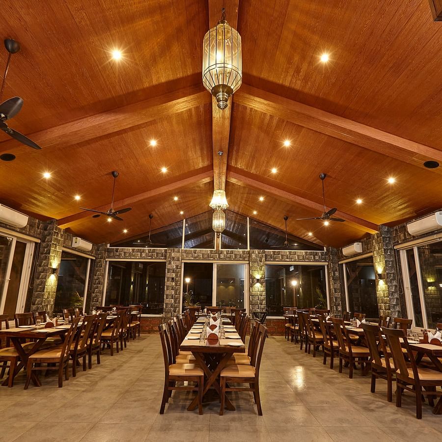 Spacious indoor restaurant with high ceiling and symmetrical table arrangements for dining - Mastiff Grand La Villae Resort, Lonavala