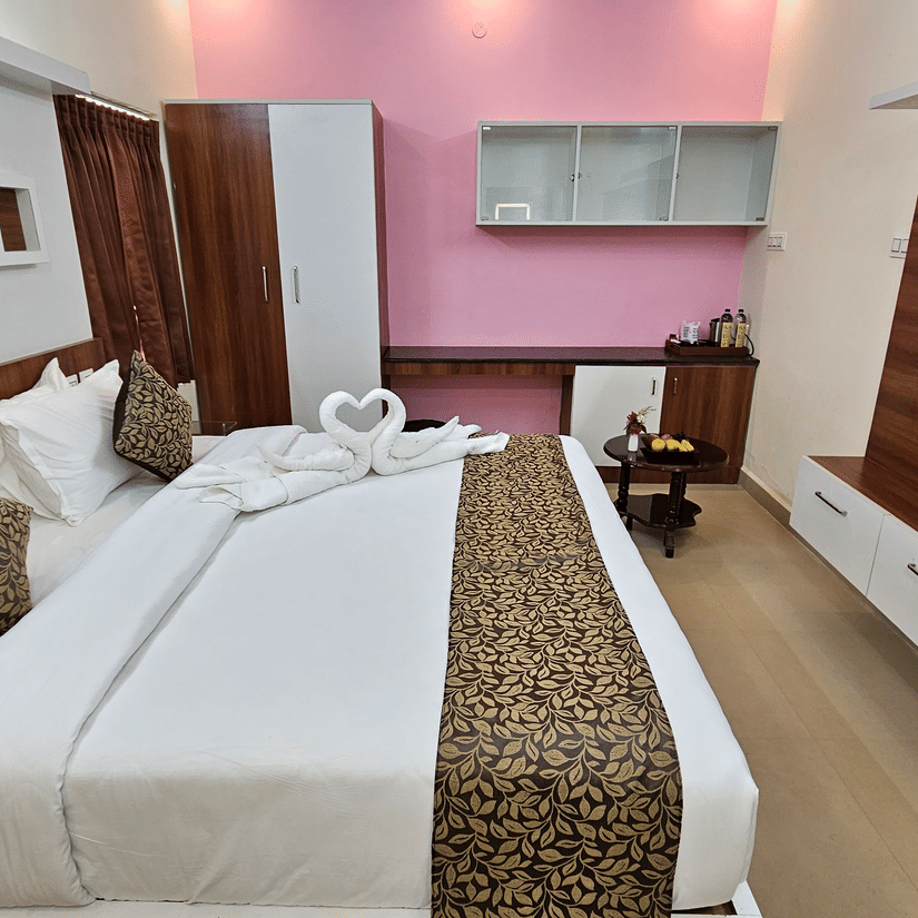 Modern room at Tio (The Indian Origin) Hotels & Resorts - Yercaud with king bed, TV, wooden interiors, and elegant decor.
