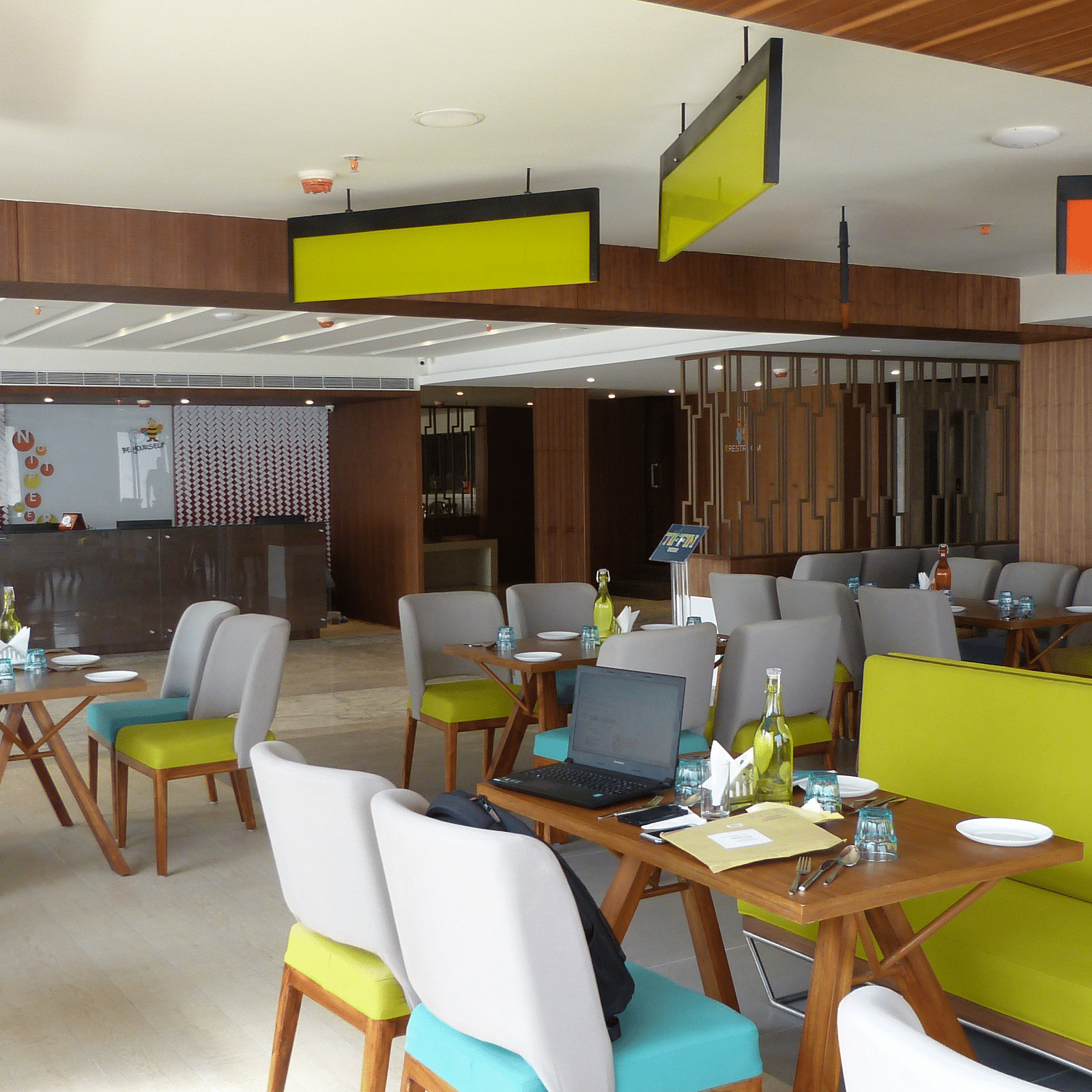 The dining area is set up with tables and chairs arranged neatly for the guests