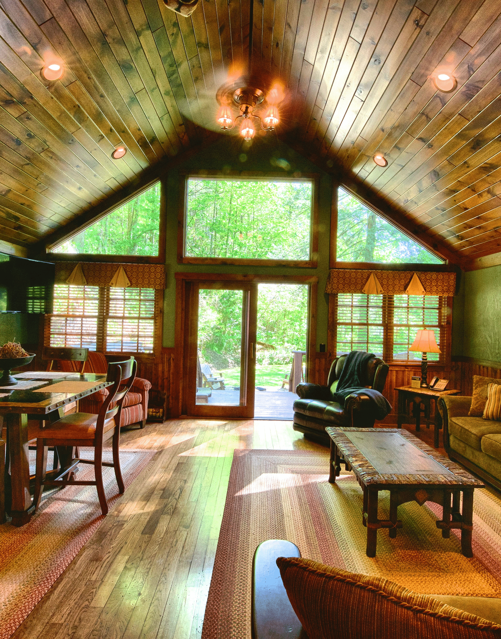 a living room with ample seating area featuring huge windows with wooden flooring and ceiling - Historic Tapoco Lodge