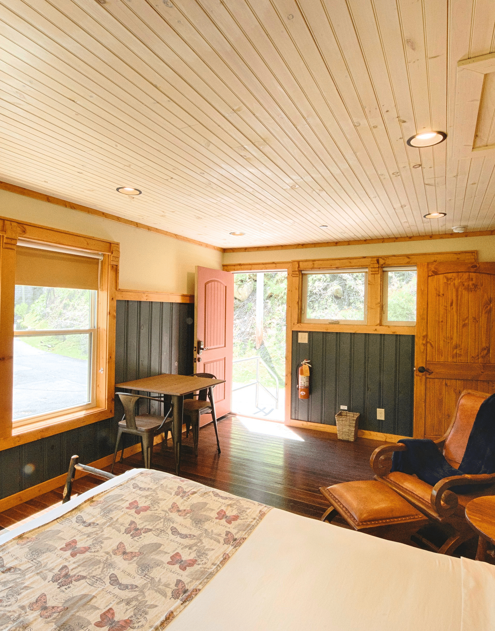 corner view of the room featuring the entry door opening tot he exterior with bright natural light
