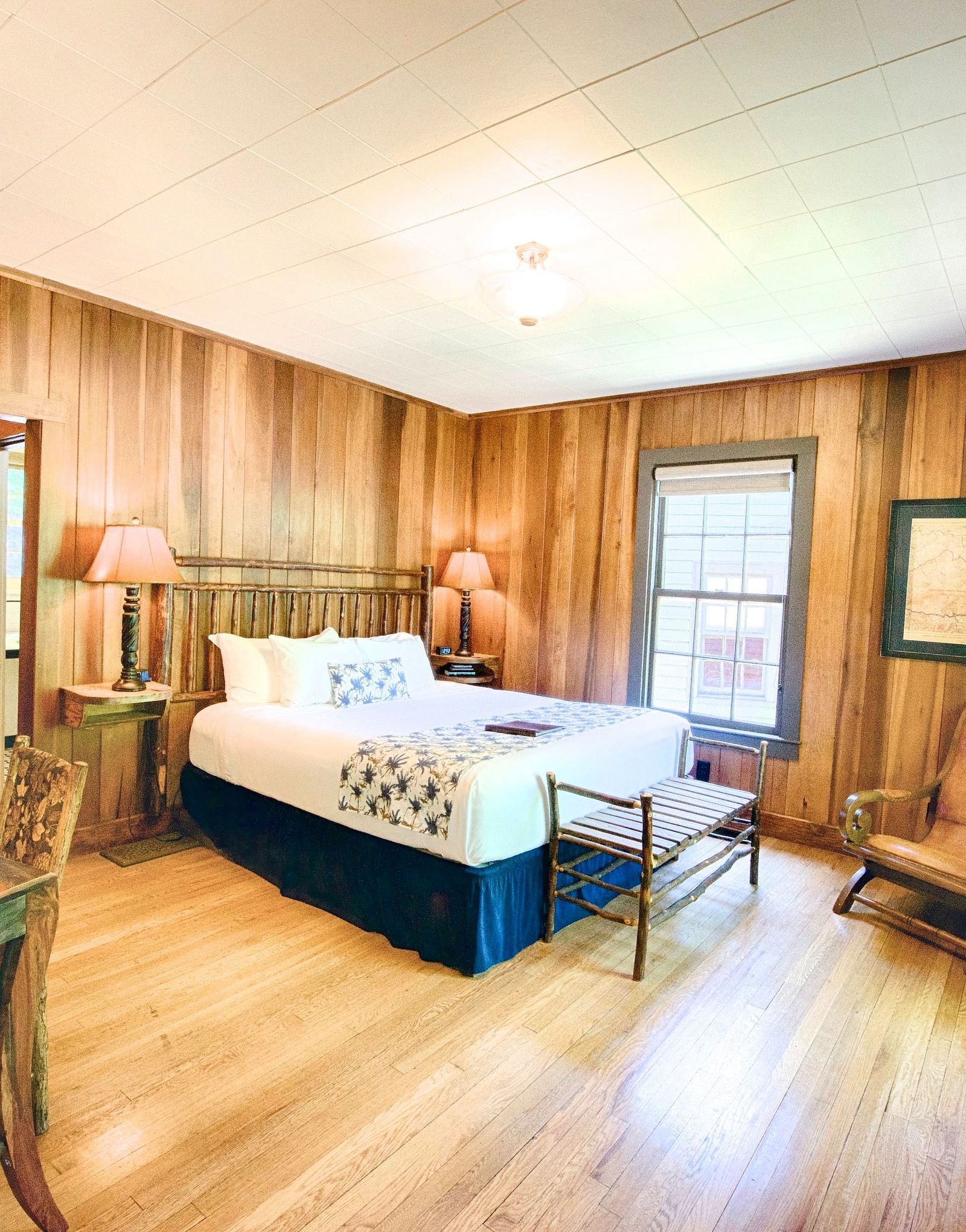full vie image of the room with a blend of modern and vintage furniture featuring a writing desk and chair in the room - Historic Tapoco Lodge