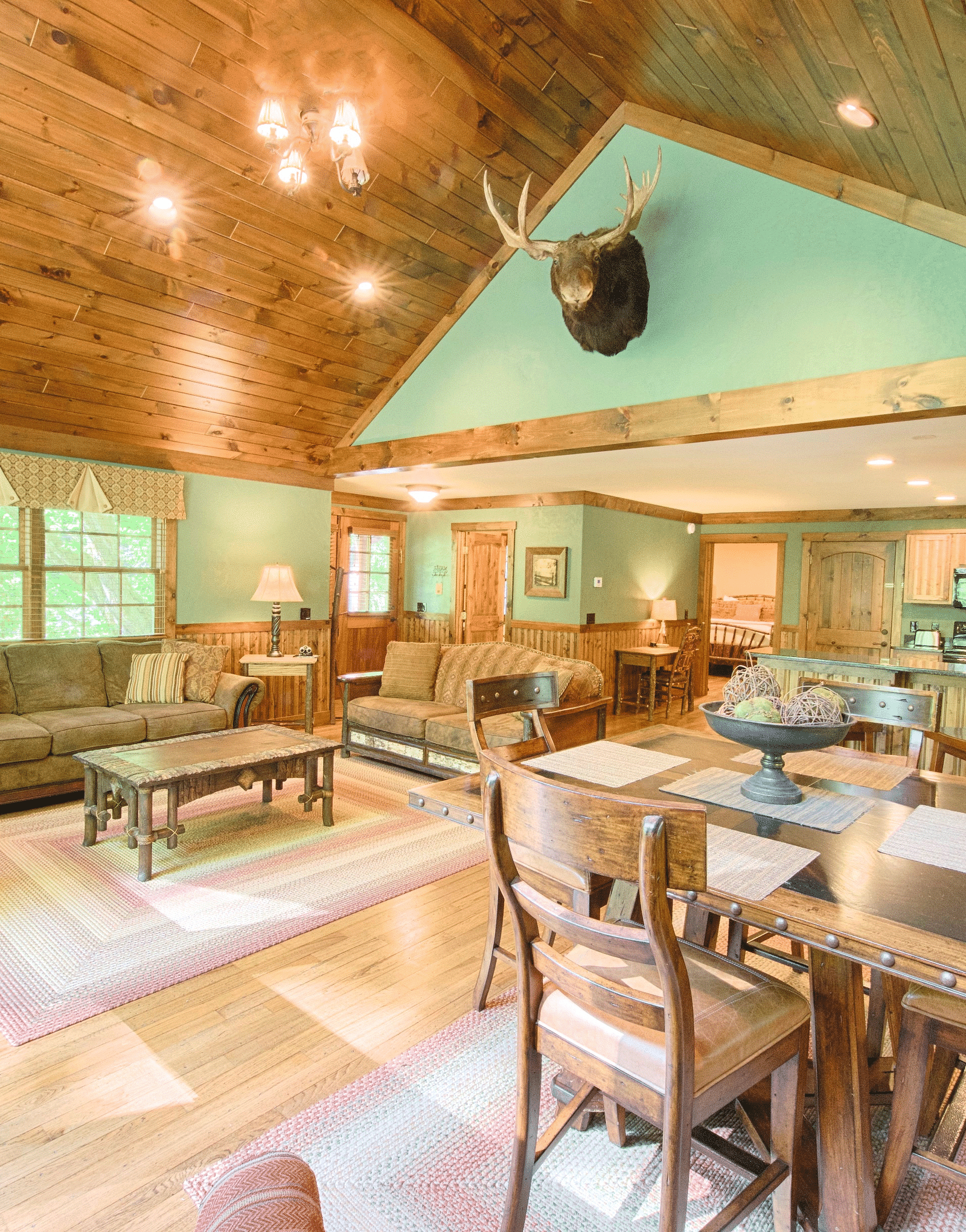 corner view image of a bright living area with plush furnishings - Historic Tapoco Lodge