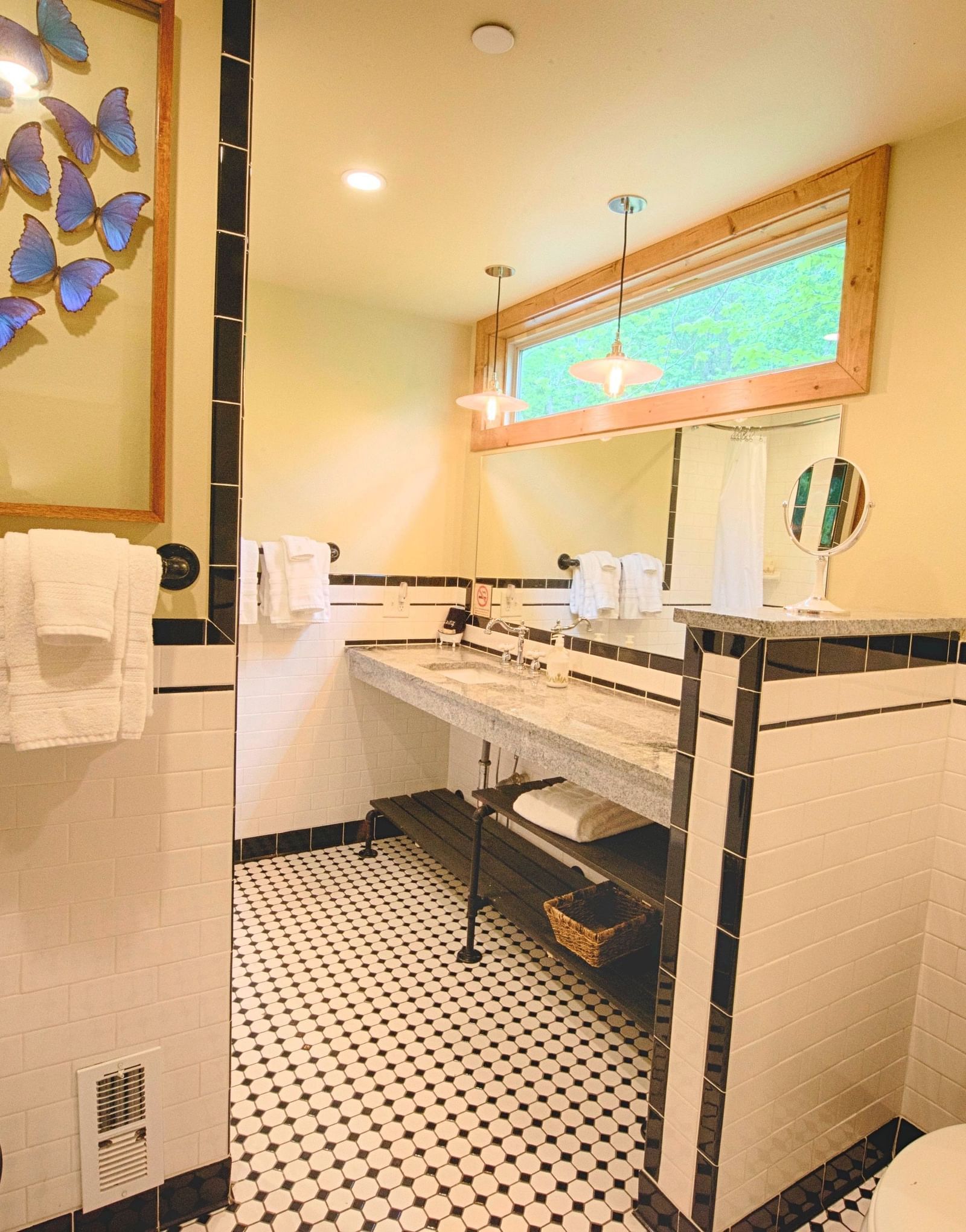 a bathroom featuring a commode and the washbasin along with a beautiful wall hanging decoration - Historic Tapoco Lodge