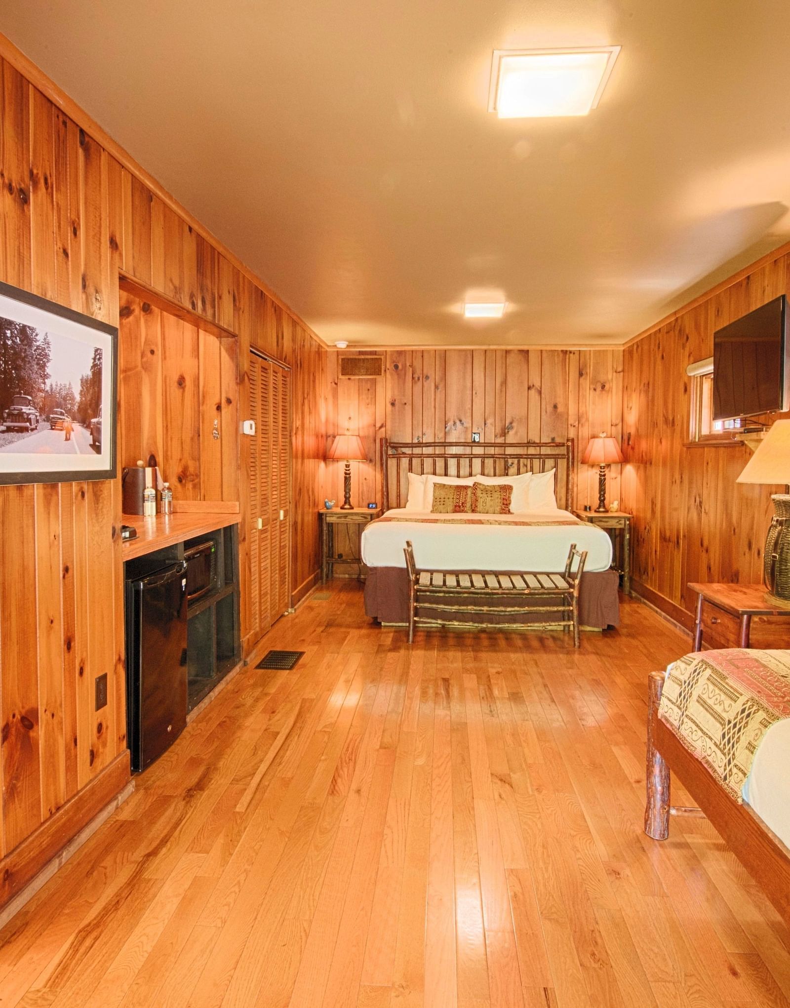 full view image of a bedroom with wooden interiors featuring two beds - Historic Tapoco Lodge