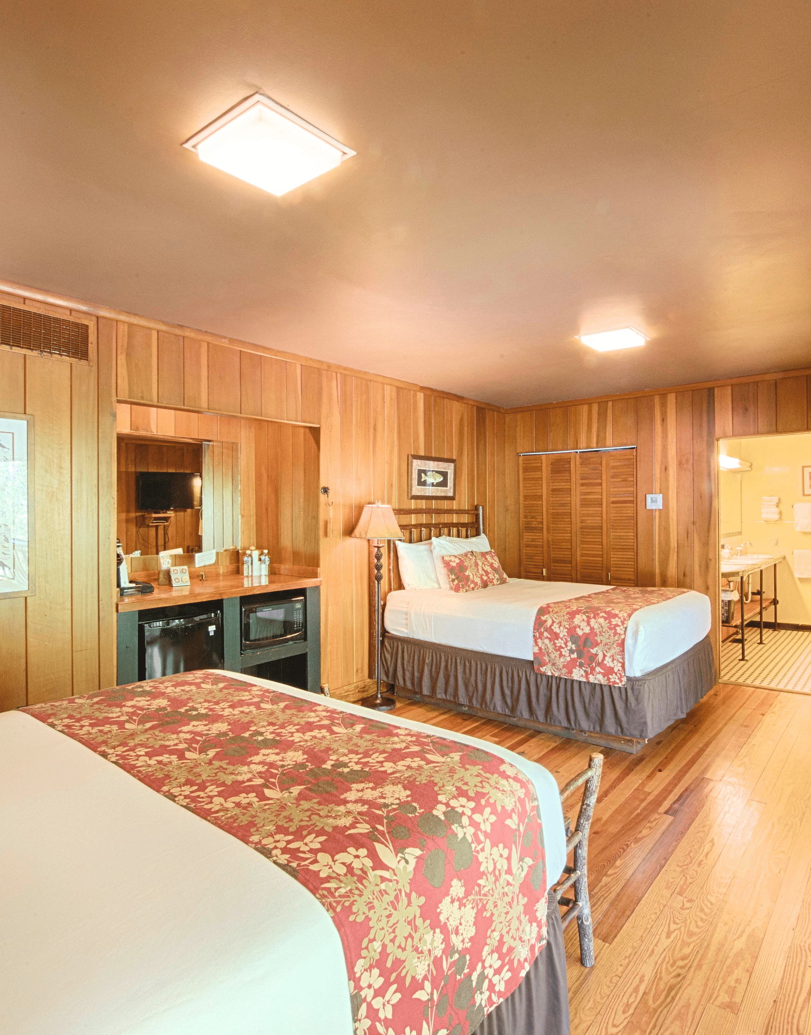 corner view of a cozy bedroom with wooden interiors featuring tow bedsfull view image of a bedroom with wooden interiors featuring two beds - Historic Tapoco Lodge