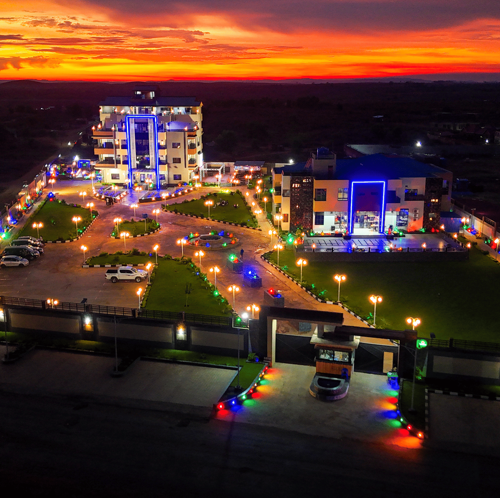 Exterior view of a building and grounds illuminated under bright orange sky - Luffu Club