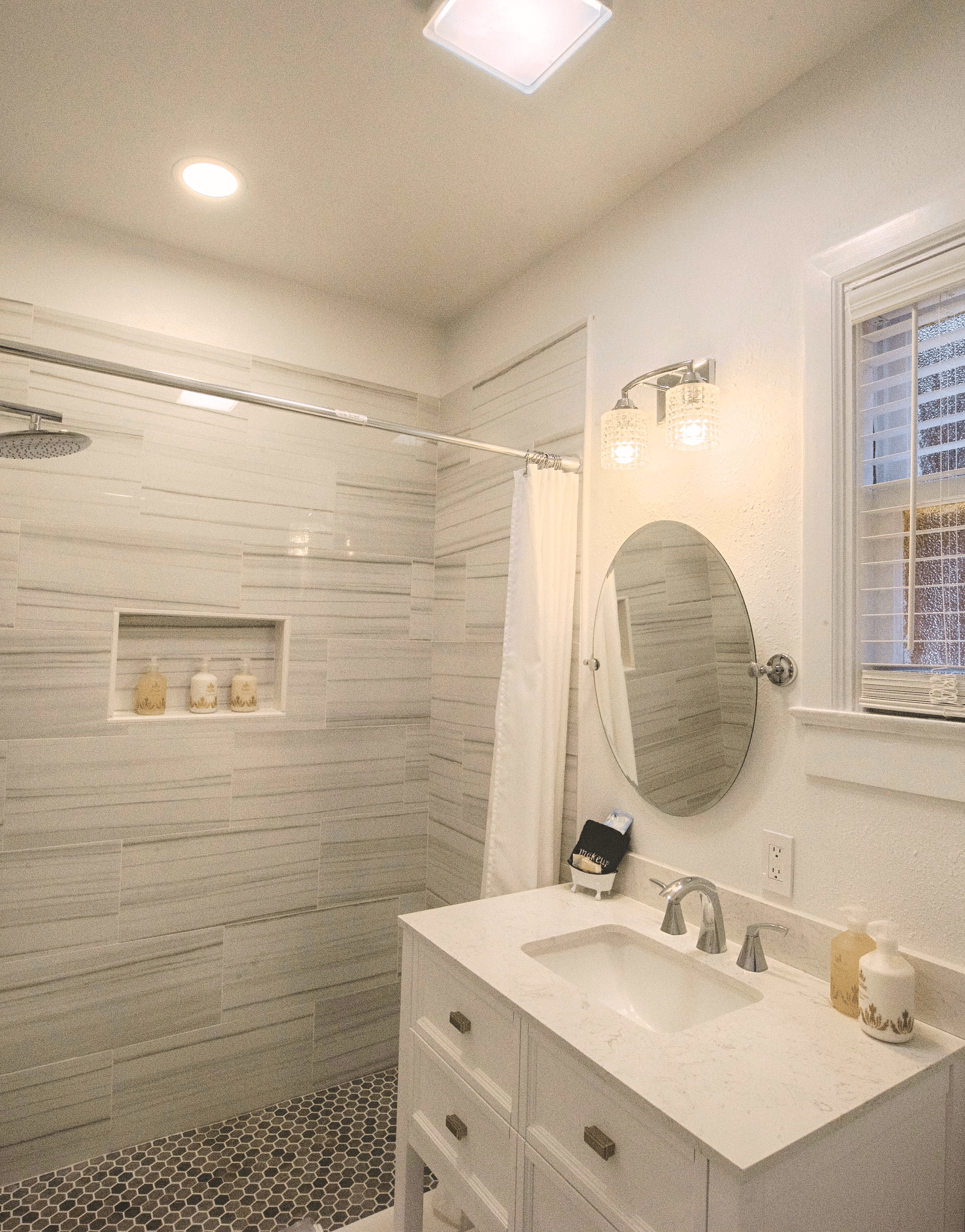 a bathroom with white and grey interiors with a well kept vanity area along with a huge window in front of it - Historic Tapoco Lodge