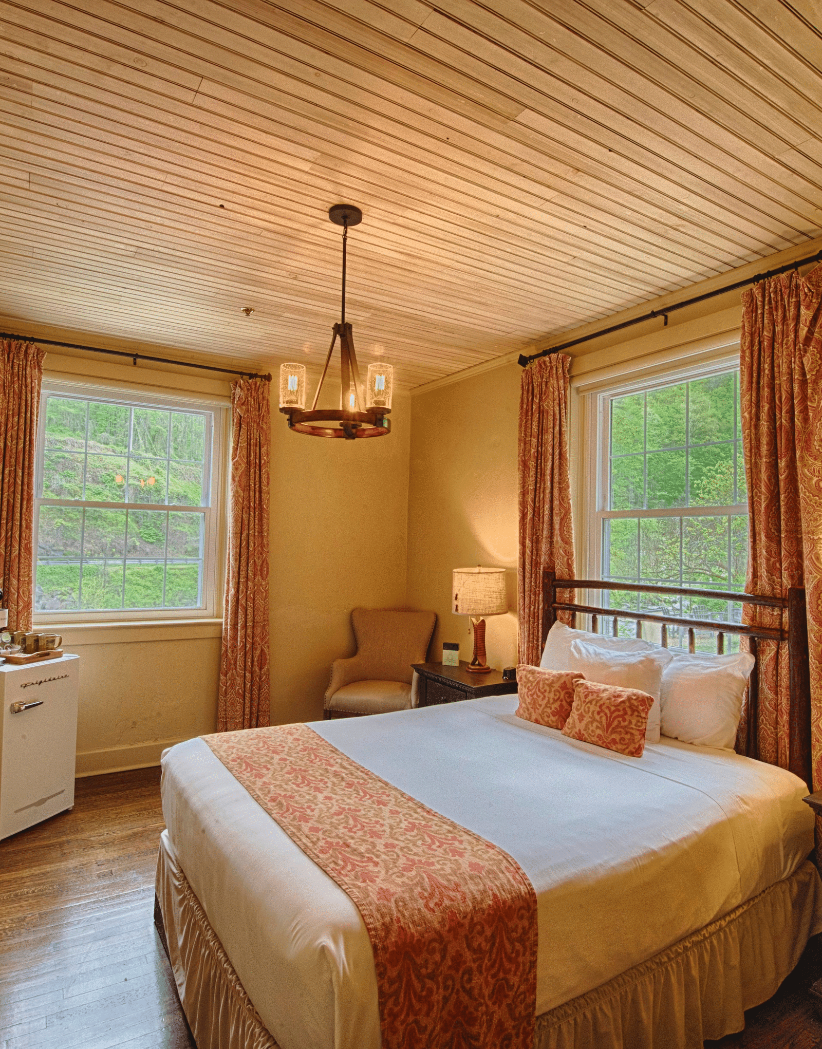 full view image of a bedroom with two huge windows with open curtains - Historic Tapoco Lodge