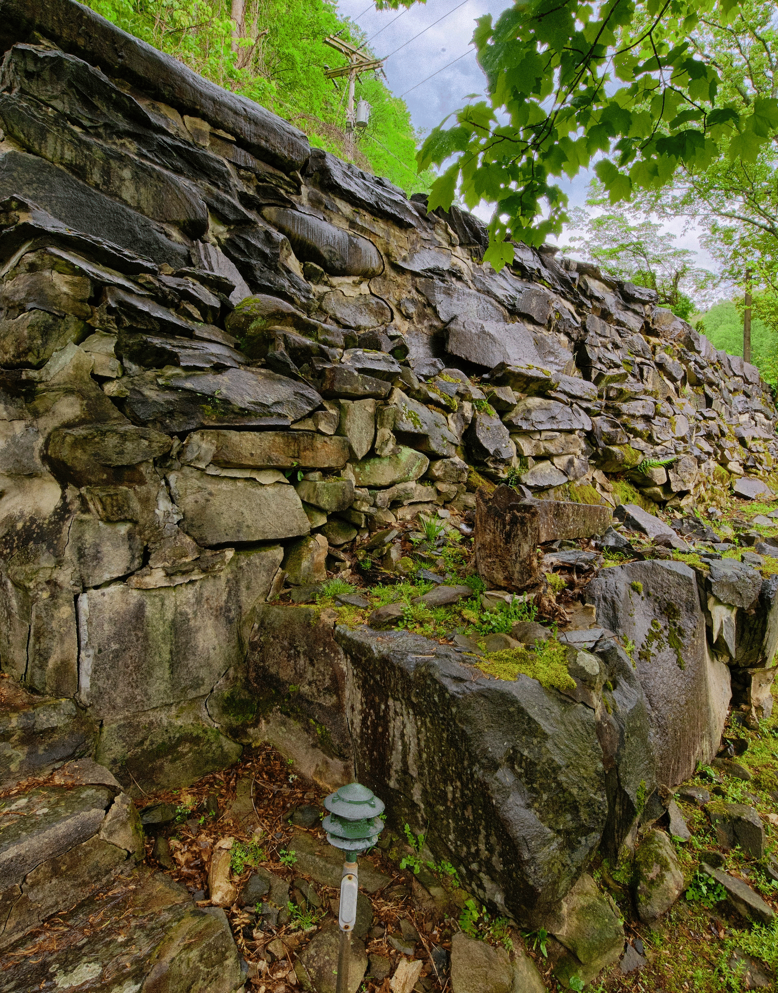 a huge stone wall with a stairway going uphill - Historic Tapoco Lodge