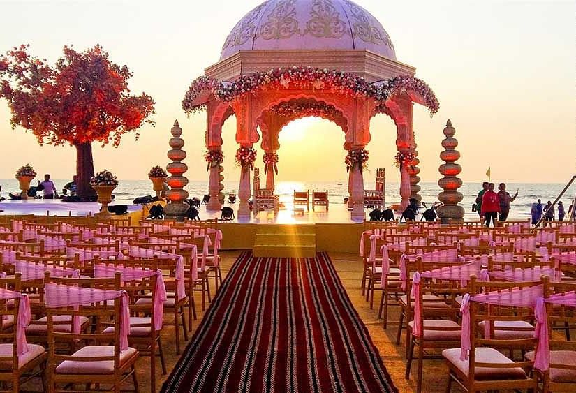 seating arrangements with a stage under a canopy for a wedding