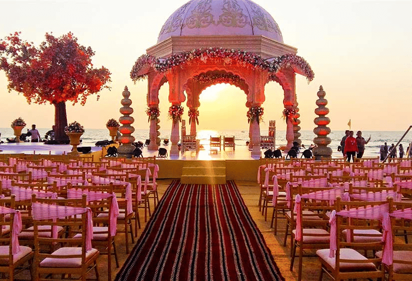 seating arrangements with a stage under a canopy for a wedding